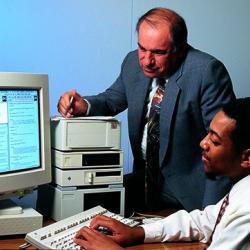 AnSim President Paul Patti watches as Jeffrey Meade demonstrates the graphical user interface