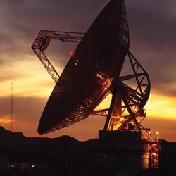 Large satellite dish at sunset