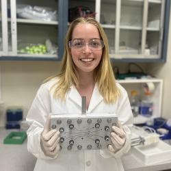 Princeton University undergraduate Kate Sheldon holds a prototype of the Agnostic Life Finder, or ALF