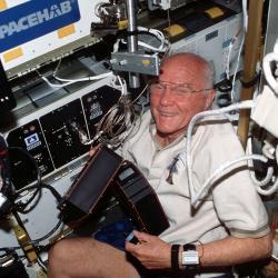 Legendary astronaut and U.S. Senator John Glenn facilitates ADSEP experiments on a space shuttle Discovery mission in 1998