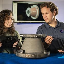 NASA engineers Tessa Fedotowsky and Ben Williams inspect a 3D printed aluminum nozzle