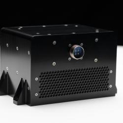 A black metal box covered in screws and with a single computer connector point.