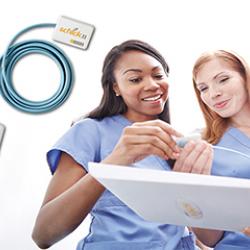 Medical professionals holding a Medical professionals holding a Schick dental imager