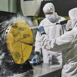 Engineers cleaning test mirror