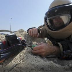 An explosive ordnance disposal worker diffuses a bomb