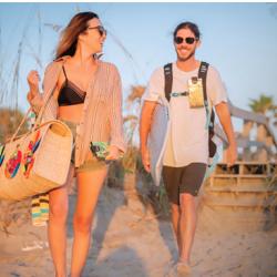Two beachgoers carrying Phoozy insulated smartphone cases