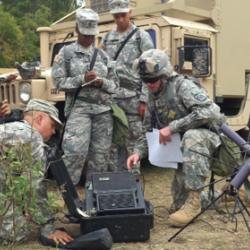 RMV Technologies is one of the few companies that offers hands-on training for best practices in avoiding electrostatic discharge during manufacturing, handling, and storage of sensitive electronics. Their seminar benefited from input from NASA, and is now being offered widely. The U.S. military is one customer. Image courtesy of U.S. Army Service members crowd around field communication equipment